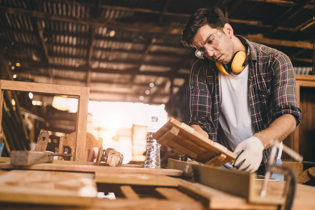 Cabinet maker finishing a custom piece in the workshop