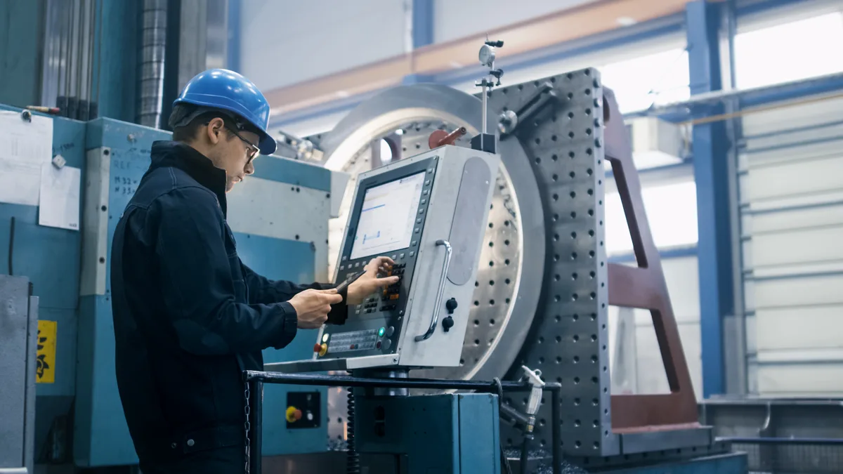 Machinist setting up a CNC machine