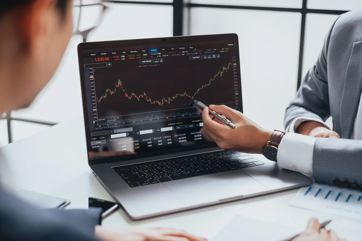 Crypto trader reviewing markets on a laptop