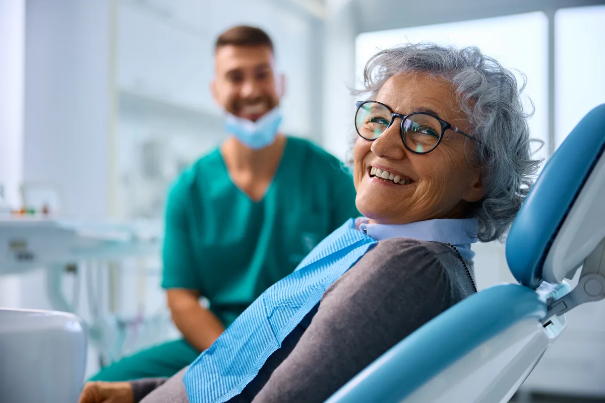 Dentist treating a patient in a modern operatory
