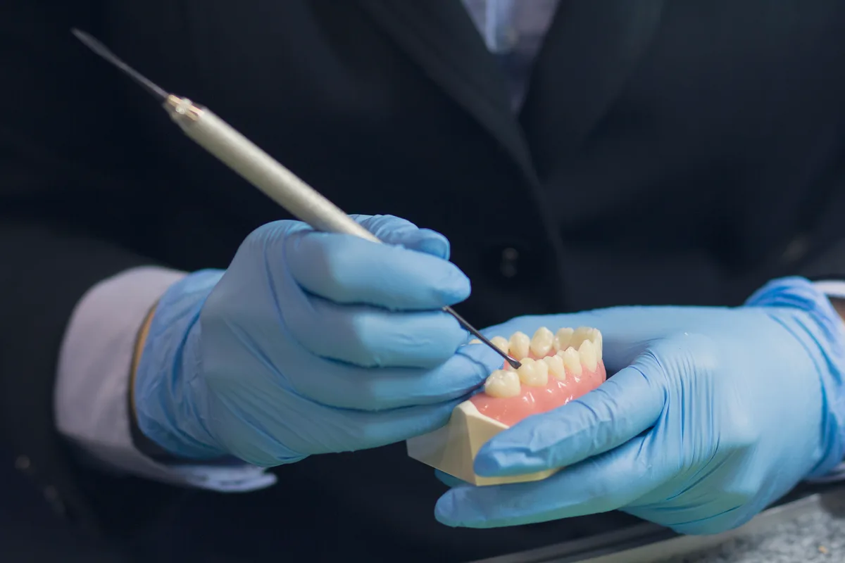 Denturist working on a denture in a clinic lab