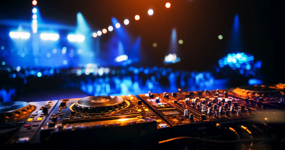DJ working a mixing console