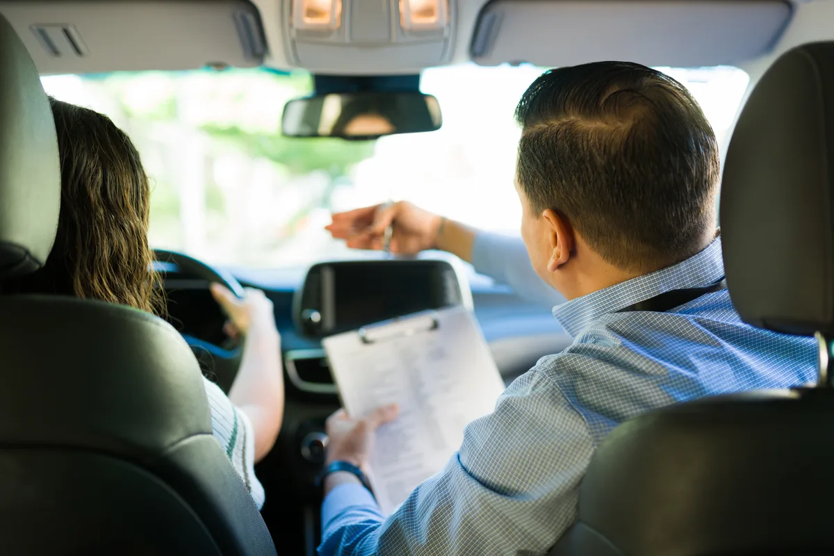 Driving instructor with a student in a training car