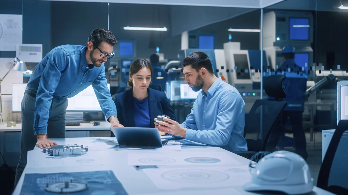 Engineers reviewing technical plans together
