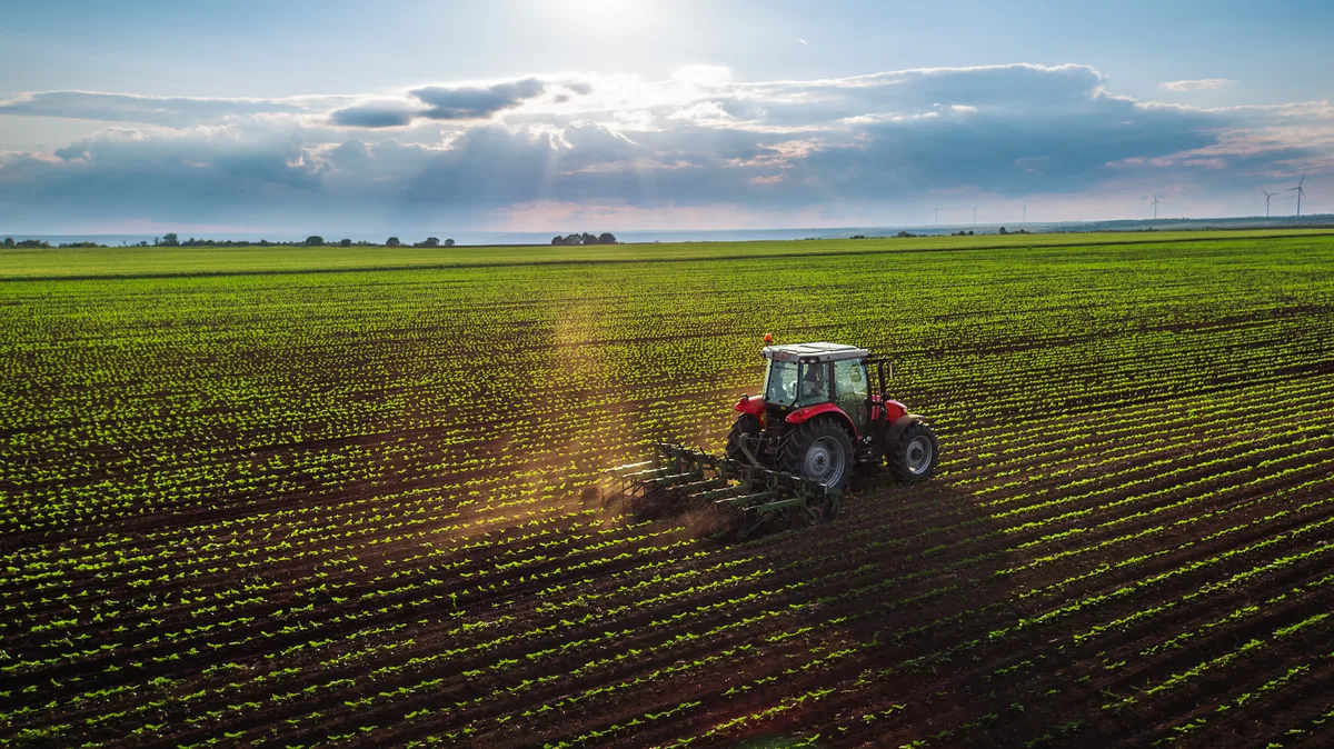 Farmer driving a tractor across a field