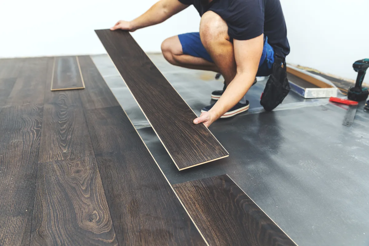 Installer laying hardwood flooring