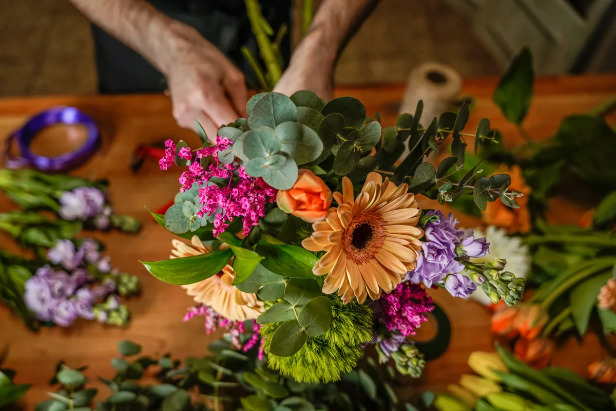 Florist arranging a bouquet in the shop