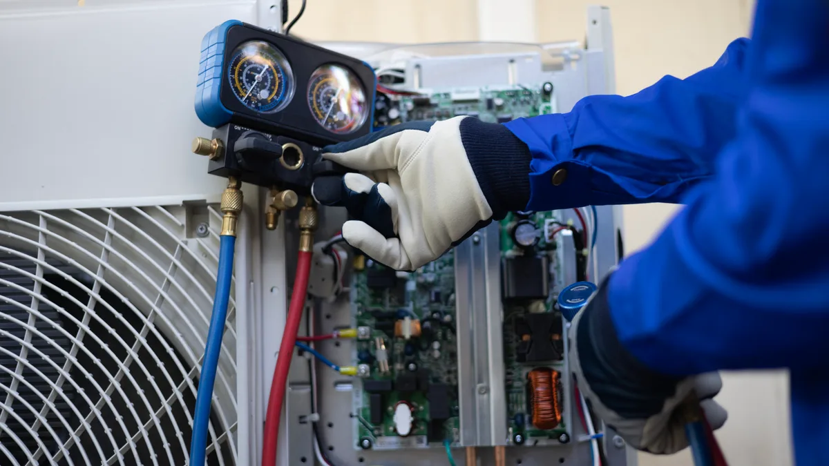 HVAC technician servicing a rooftop unit