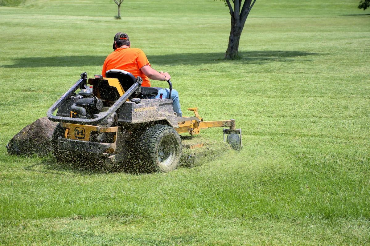 Landscaper mowing a commercial property