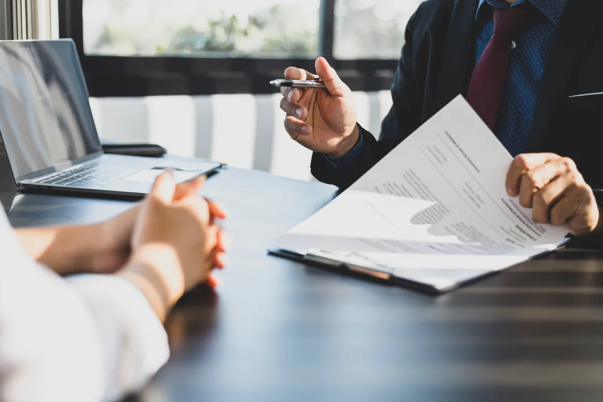 Mortgage broker reviewing documents with clients