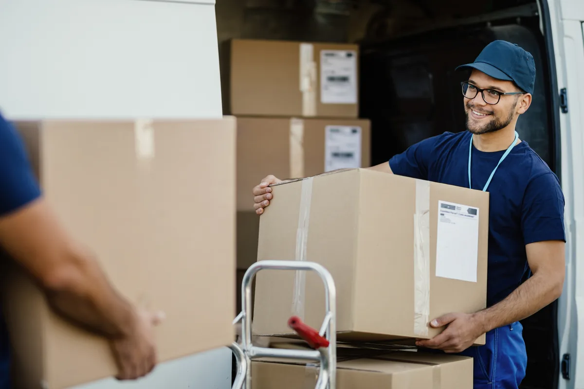 Movers loading boxes into a truck