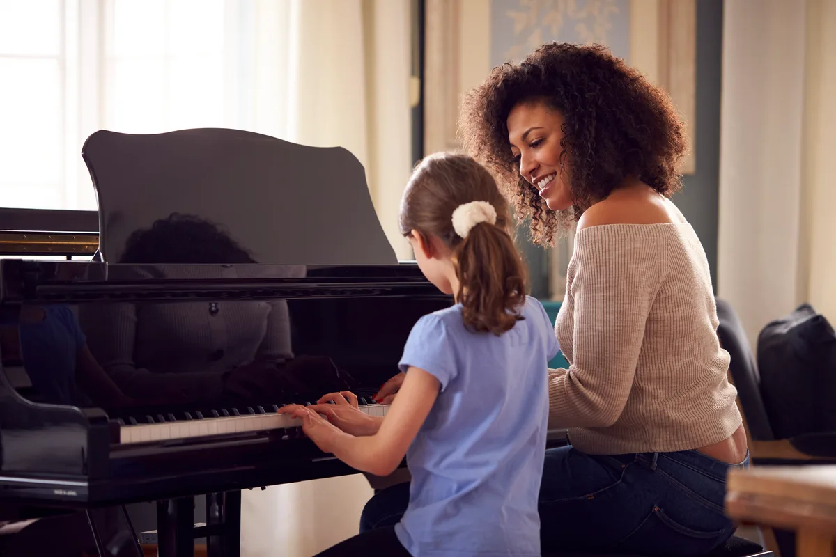 Music teacher giving a piano lesson