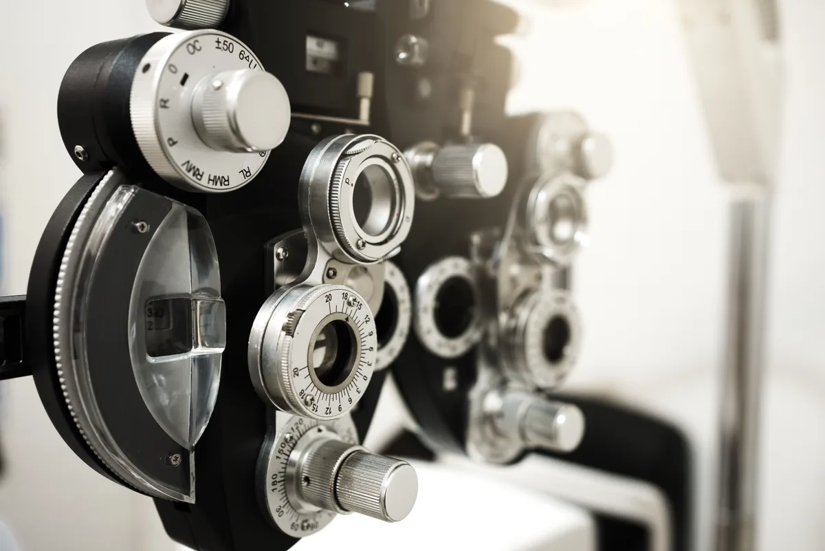 Optometrist examining a patient with a phoropter