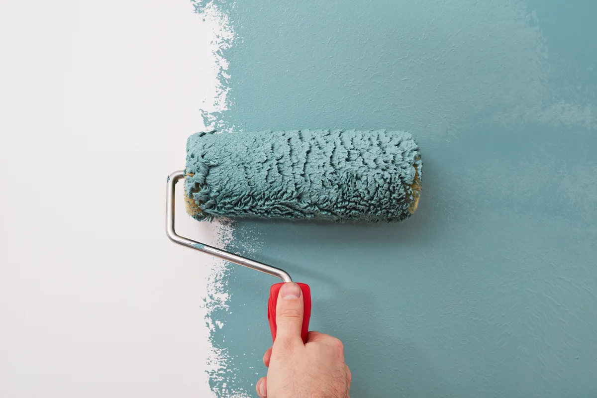 Painter rolling a wall on a residential job