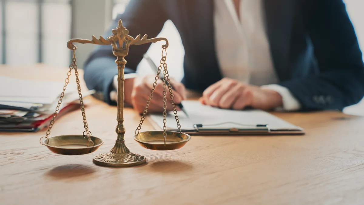 Paralegal reviewing case files at a desk