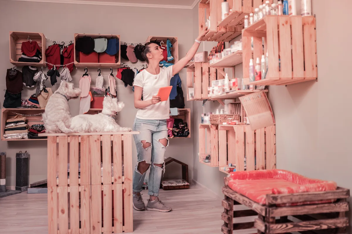 Pet store owner stocking shelves
