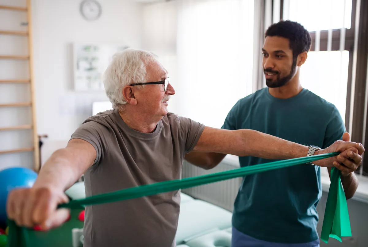 Physiotherapist guiding a patient through rehab