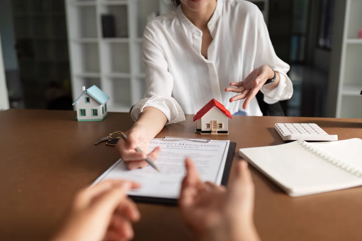 Real estate agent showing a property to clients