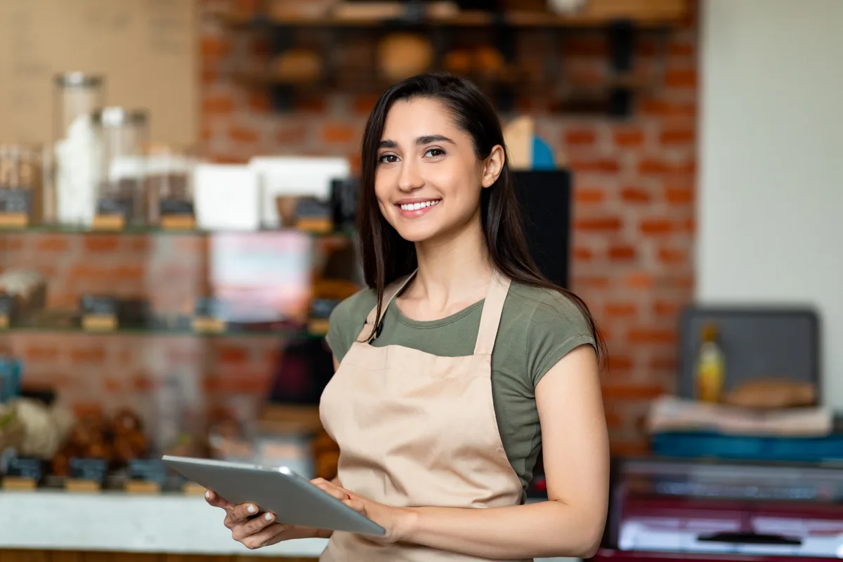 Restaurant owner standing in their dining room