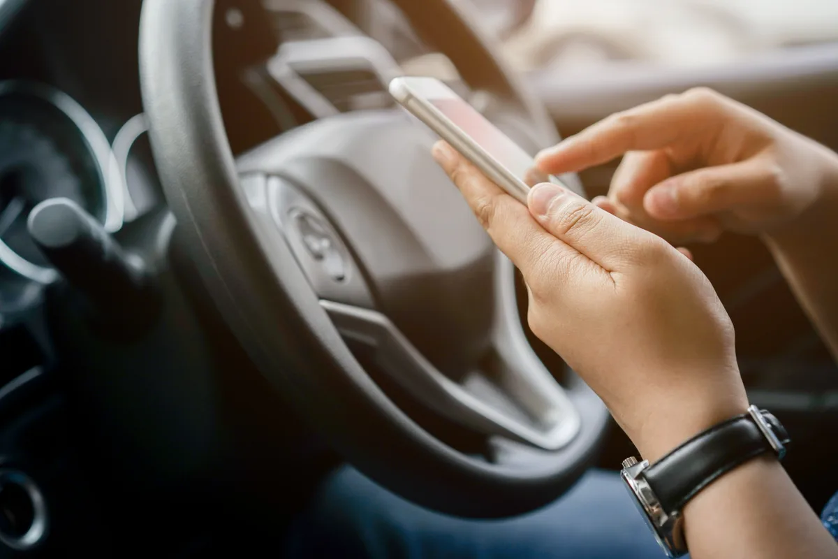 Rideshare driver at the wheel with a navigation app