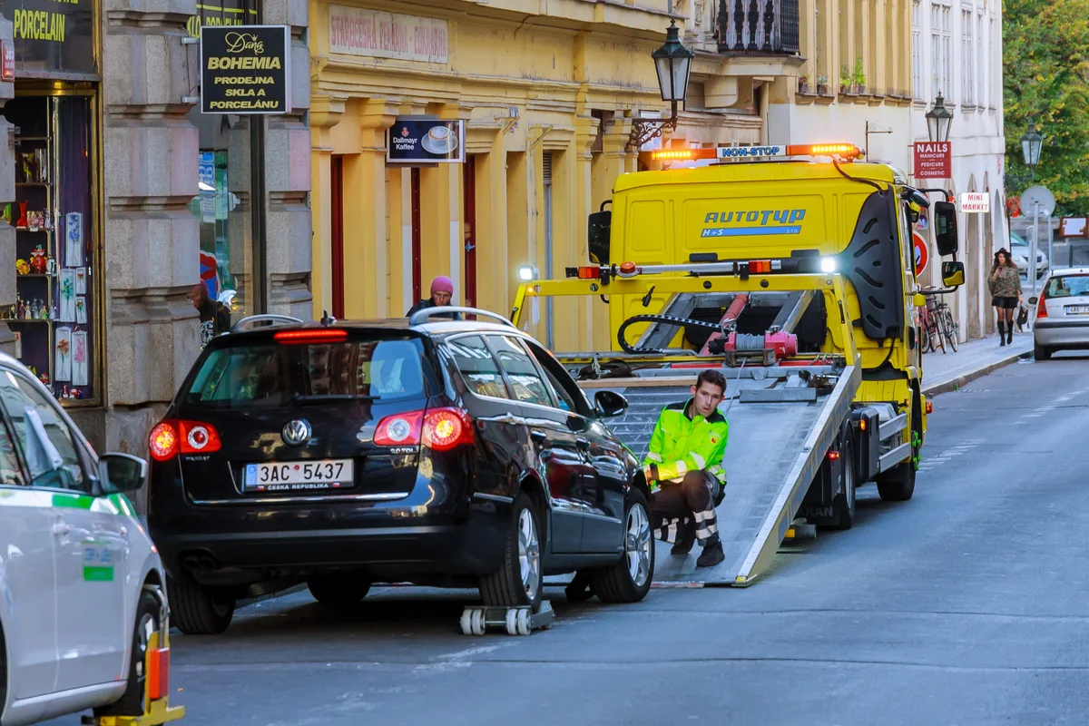 Flatbed tow truck loading a vehicle
