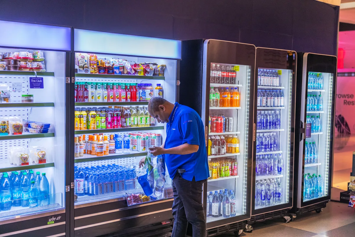 Operator restocking a vending machine