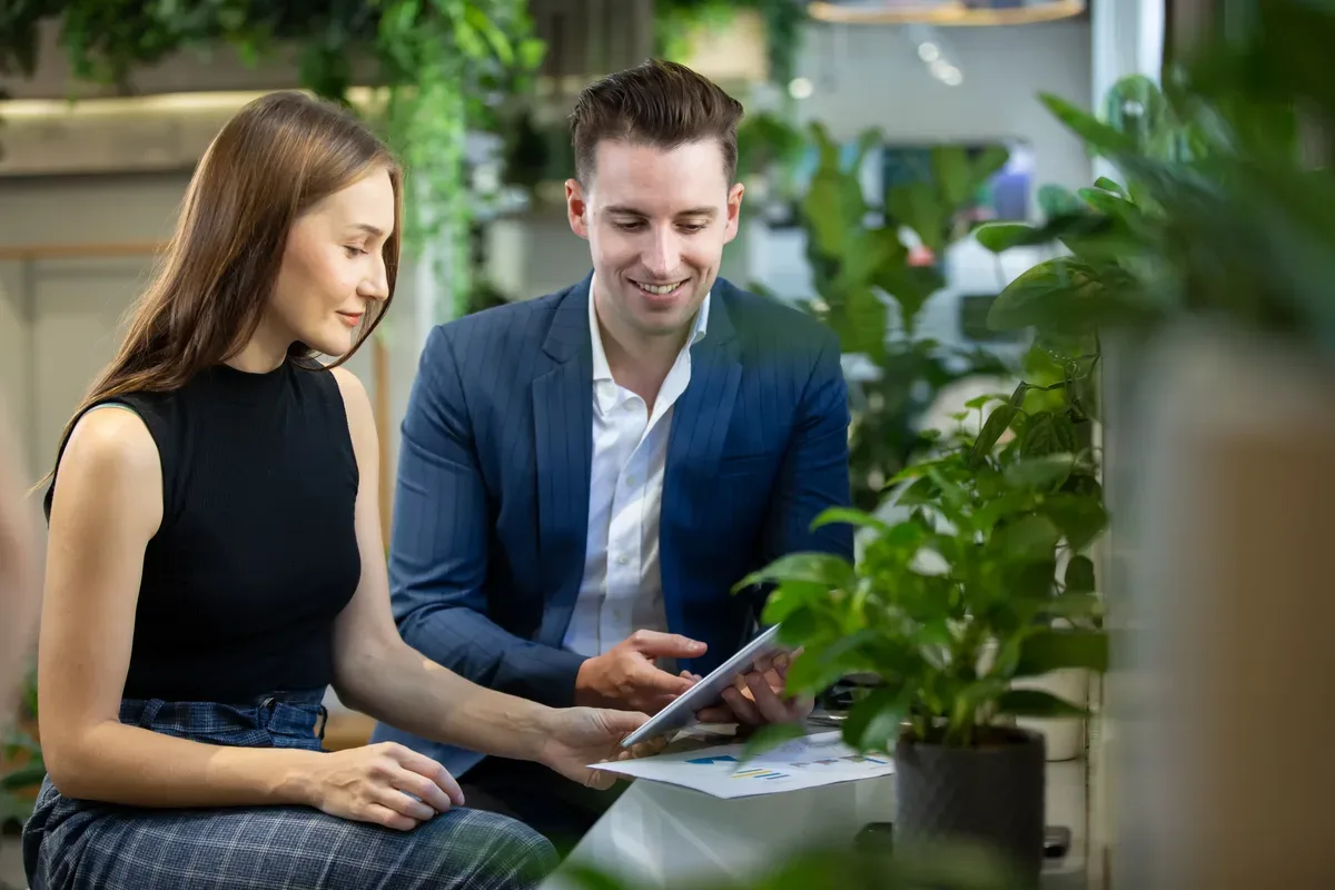 A CPA walking a business owner through the numbers on a tablet