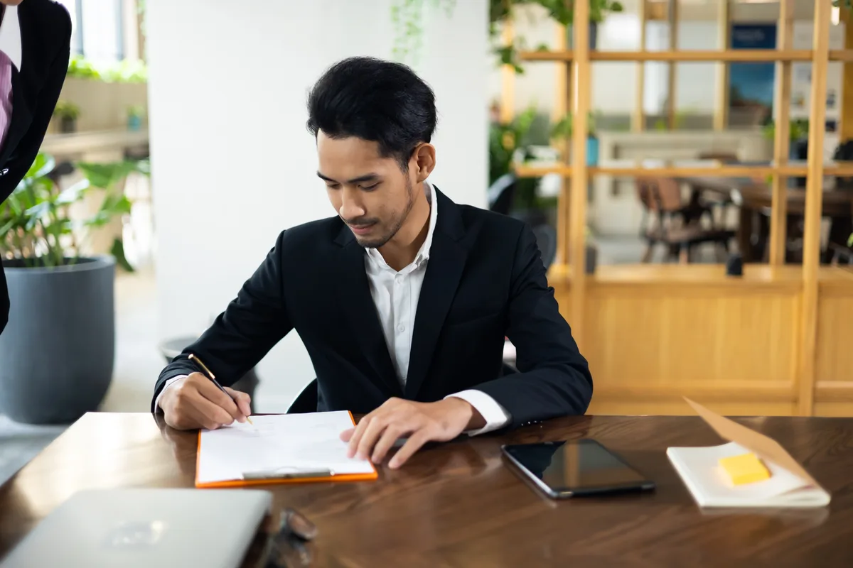 A business owner signing incorporation paperwork