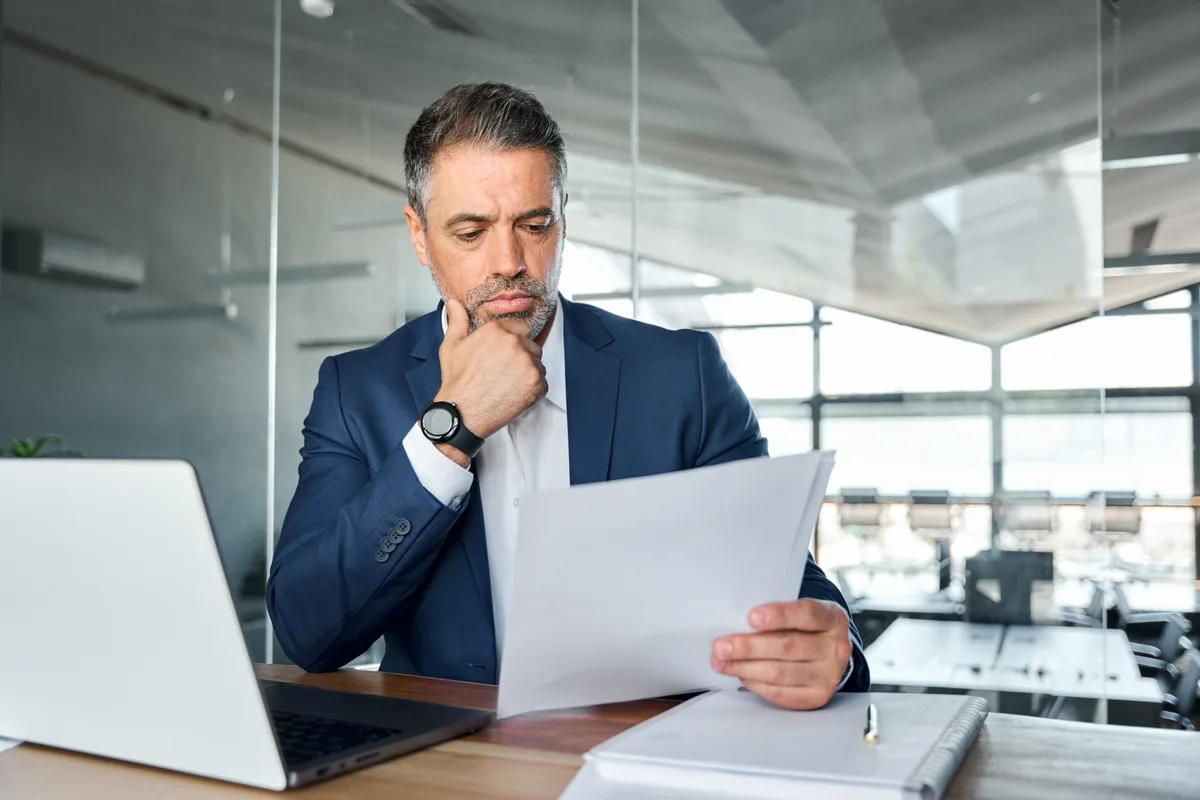 A business owner reading through his corporate tax review