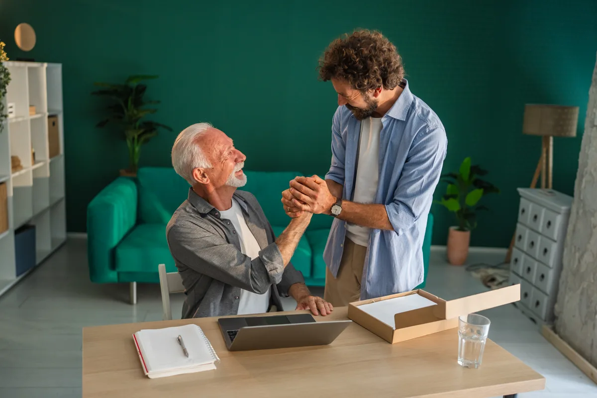 A founder and his successor shaking hands over the plan